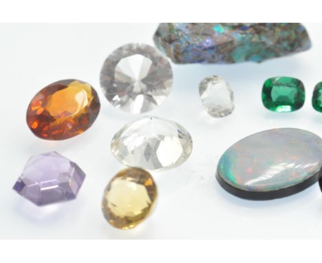 Two rough pieces of precious opal together with a quantity of loose gemstones. The opal found in Australia having green blue 
