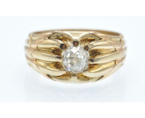 An antique 18ct gold and diamond ring. The ring set with an old cut diamond in a scalloped prog setting having x motif should