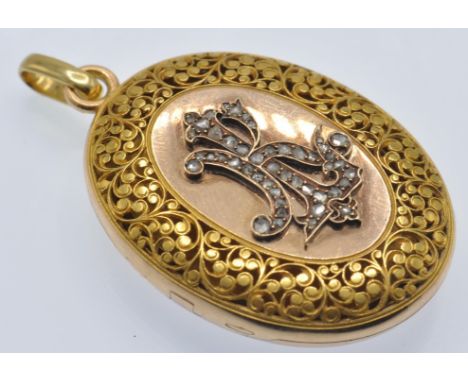 An antique French 18ct gold and diamond locket pendant. The locket having pierced foliate decoration to front with central ro