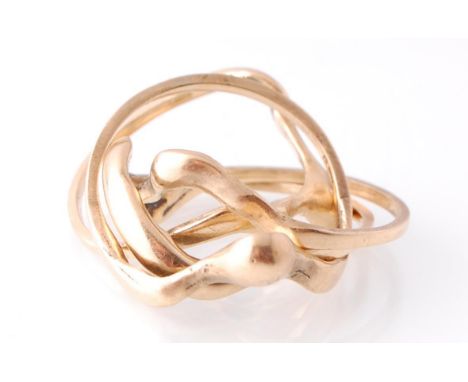 A 9ct gold hallmarked 4 part puzzle ring with serpentine drop form being stamped to each ring. Total weight 5.8g / Size K
