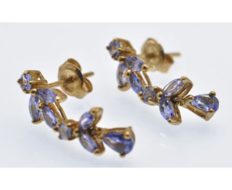 A pair of 9ct gold and gem set pendant earrings. The earrings having round and mixed cut purple stones - likely amethyst - st