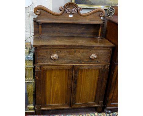 Regency Rosewood Secretaire Chiffonier, the shaped top rail decorated in relief with a large shell, over a gallery shelf and 