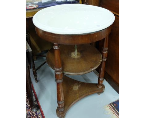 Circular ceramic sink, with leaf impressed soap trays, in a mahogany base, with 3 turned leg supports, on castors, 2ft dia x 