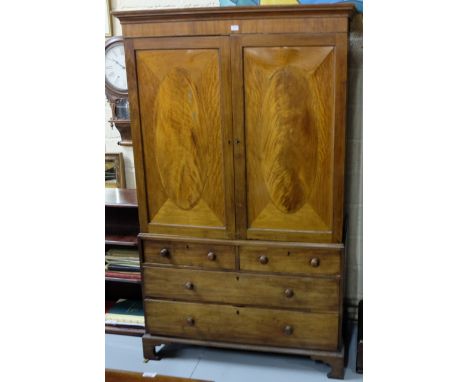 Georgian Mahogany Gents Wardrobe, the 2 flame mahogany upper doors over a base with 2 short drawers and 2 long drawers, brack
