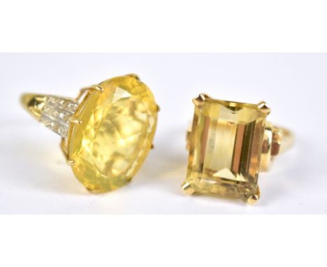 A 9ct yellow gold dress ring set with large oval cut yellow coloured stone and white stone chips to shoulders, size K, and a 