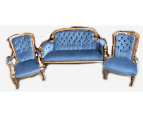 A late 19th century walnut three piece salon suite, comprising button backed canopy, elbow chair and side chair, all raised o