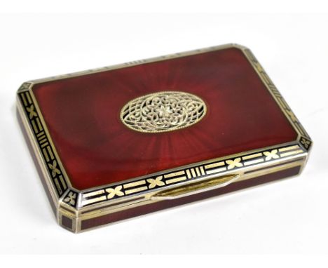 An Austro-Hungarian silver gilt and red enamelled snuff box of rectangular form with canted corners, the lid with pierced ova