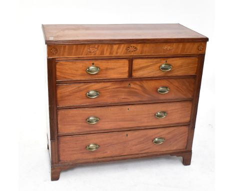 A Georgian inlaid mahogany chest of two short over three long drawers raised on bracket feet.