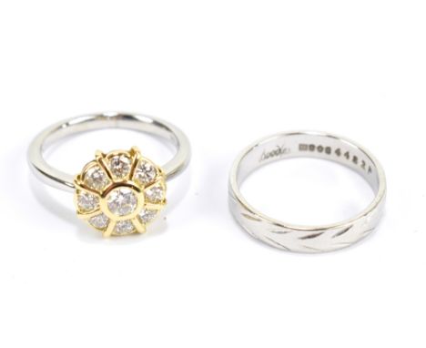 BOODLES; a platinum and yellow metal diamond cluster ring, the central diamond weighing 0.30ct, with an approx total carat we