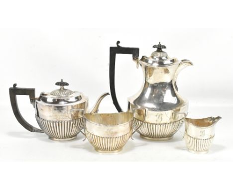 GF WESTWOOD &amp; SONS; a George V hallmarked silver three piece tea service, with gadrooned detail, length of teapot 24cm, B