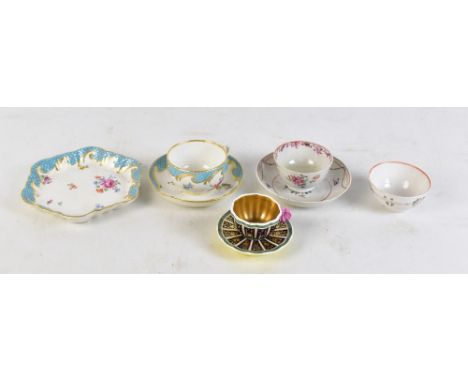 A group of porcelain cups, tea bowls and saucers including enamel decorated New Hall duo, a Spode duo, the tea cup handle mod