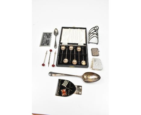 A small group of silver including a dessert spoon (af), a vesta case, teaspoon, three cocktail spikes and a cased set of six 