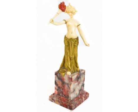 LOUIS SOSSON (fl. 1905-1930); an Art Deco bronze and ivory figure depicting a semi-naked young woman holding a torch aloft on