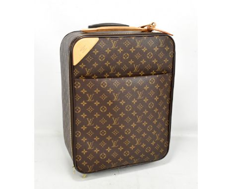 LOUIS VUITTON; a Pegase Cloth cabin sized suitcase, with brown monogram coated cloth, and nude leather handles and details, 4