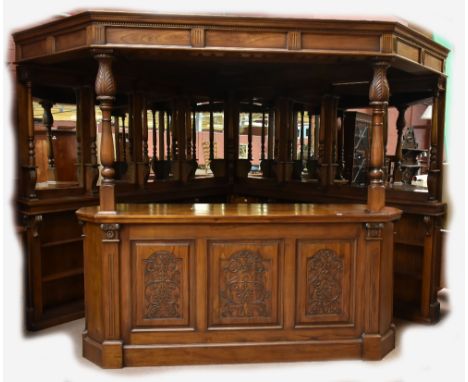 A large and impressive bar with triangular sectioned canopy above eight bevelled mirrors flanked by turned columns above shel