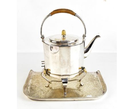 An Arts &amp; Crafts silver plated electric kettle on stand with rattan detail to the swing loop handle, height when handle d