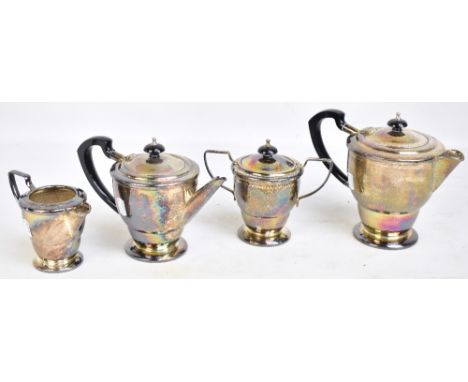 BIRMINGHAM PLATE &amp; CUTLERY LTD; a George VI hallmarked silver four piece tea service with hammered finish, comprising tea