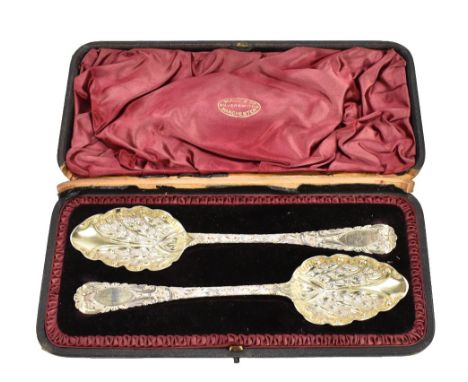 WILLIAM RAWLINGS SOBY; a pair of William IV hallmarked silver berry spoons with repoussé foliate scroll detail, Exeter 1835, 
