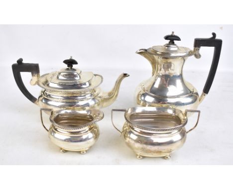 BARKER BROS; a George V hallmarked silver four piece set comprising teapot, length 28.5cm, hot water pot, twin handled sugar 