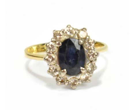 An 18ct yellow gold, diamond and sapphire cluster ring, mark to band interior, size L 1/2, approx 3.1g.Additional Information