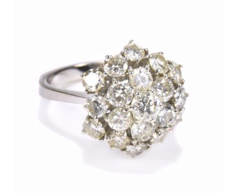 A white metal diamond cluster ring, the central diamond weighing approx .25ct, the inner band stamped 18ct, size M-N, approx 