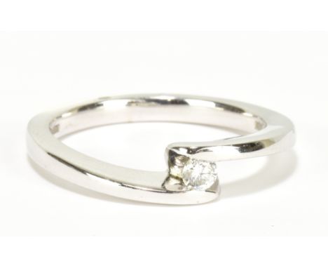 A 9ct white gold diamond solitaire ring with crossover shank, size O, approx 3.8g.