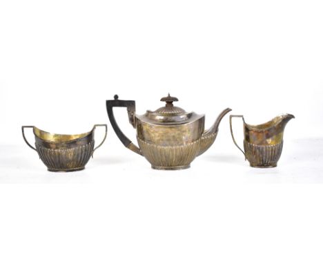 A matched hallmarked silver three piece tea service, each with gadrooned lower body, the teapot with friendship inscription, 