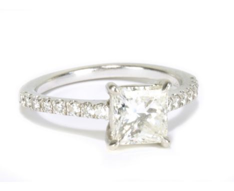 A platinum and diamond solitaire ring with central princess cut diamond weighing 1.52cts, with sixteen further diamond chips 