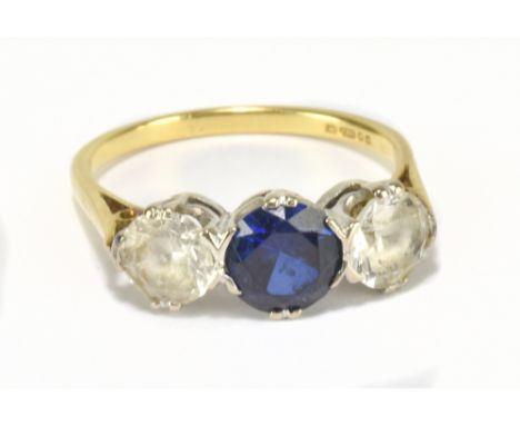 An 18ct yellow gold and synthetic corundum three stone dress ring, size Q1/2, approx 4.65g.