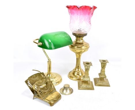 A small group of brass items to include a Victorian oil lamp with cranberry glass shade, an early 20th century German inkwell
