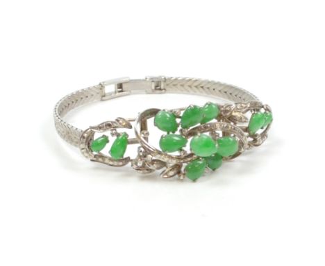 A white metal bracelet set with pear cut jade in hinged setting, apparently unmarked, length 16.5cm.