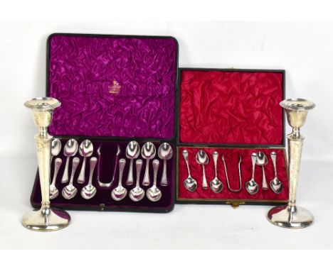 A pair of George V hallmarked silver loaded candlesticks, Birmingham 1911, height 21cm, and two cased sets of silver plated t