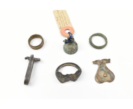 A group of antiquities including a Medieval bronze finger ring, a Medieval silver belt clip, and four small Roman finds (6).