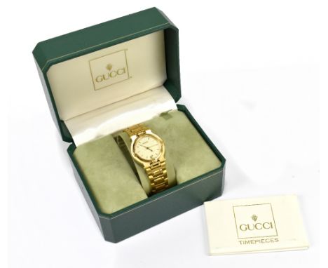 GUCCI; a gold plated wristwatch with circular dial and date aperture, sold with spare additional link, box and guarantee.Addi