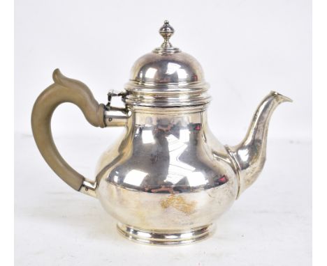 CJ VANDER; an Elizabeth II hallmarked silver teapot with cast finial on spreading circular feet, London 1968, length 25cm, ap