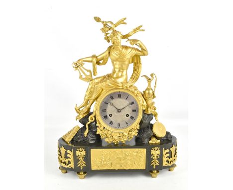 A good early 19th century French Empire bronze mantel clock with ormolu detail, featuring Bacchus seated above the eight day 