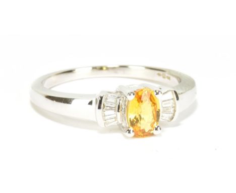 An 18ct white gold yellow sapphire and diamond ring of Art Deco design, the oval sapphire weighing approx 0.50cts with eight 