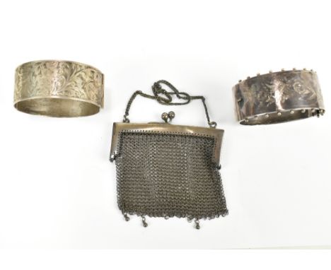 Two hallmarked silver hinged bangles with engraved foliate decoration, approx 64g, and a silver mounted mesh metal purse (3).