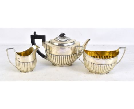 WALTER &amp; JOHN BARNARD; a Victorian hallmarked silver three piece tea set with gadrooned detail, comprising teapot, length