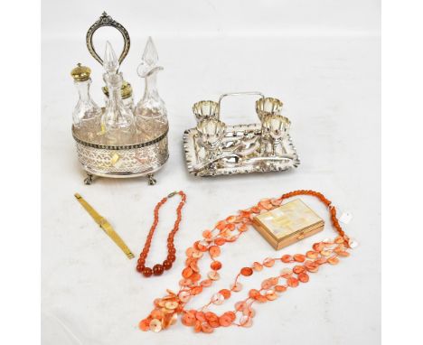 A silver plated condiment stand with pierced detail on four claw feet housing four clear glass bottles, two with electroplate