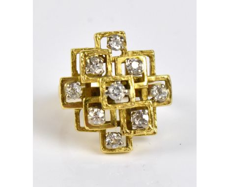 An 18ct yellow gold and diamond set ring of abstract stepped design, with nine round brilliant cut stones in an openwork fram