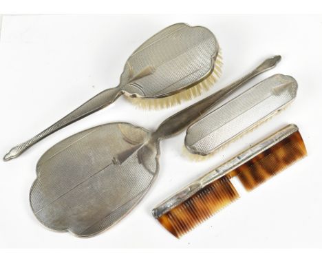 An Elizabeth II hallmarked silver four piece dressing table set, Birmingham 1955, length of mirror 34cm.