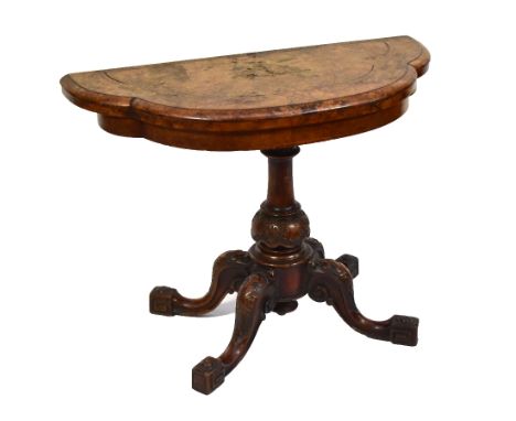 A Victorian walnut and burr walnut card table of shaped outline on turned column to four outswept legs terminating in Greek k