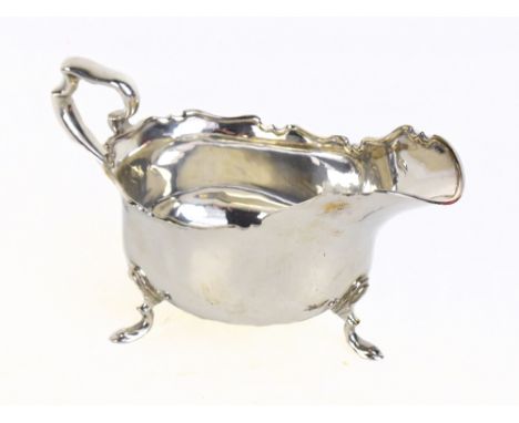 An Edwardian hallmarked silver sauce boat with shaped rim and three stepped feet, Birmingham 1906 length 20cm approx 10.37oz/