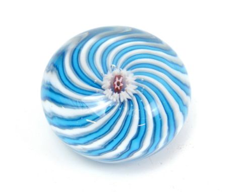 CLICHY; a circular glass paperweight with central flower cane and blue and white scrolled effect, unmarked, diameter 6cm.Addi