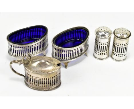 STOKES &amp; IRELAND LTD; a George V hallmarked silver five piece cruet set, each with pierced decoration, Chester 1911-12.Ad