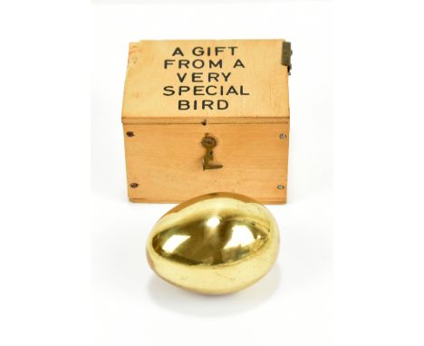 CARL AUBÖCK; an Austrian brass paperweight modelled as an egg, signed to base, length 5cm, in original box inscribed 'A gift 