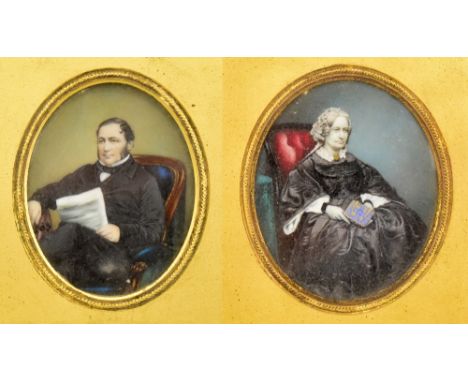 A pair of 19th century portrait miniatures depicting a gentleman and his wife in formal black dress, unsigned, both set in fl