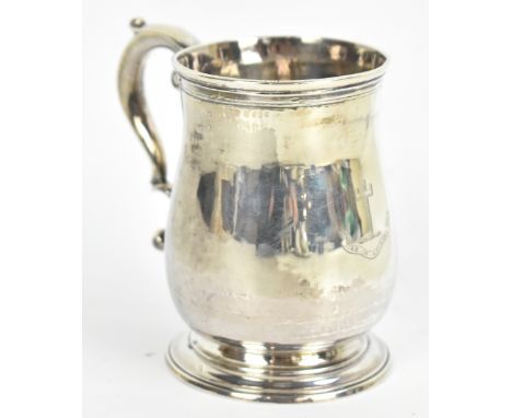 A George II hallmarked silver baluster mug, with engraved cross inscribed 'Ire In Adversa', on spreading circular foot, Londo