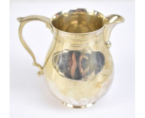 CJ VANDER LTD; an Elizabeth II hallmarked silver cream jug with reeded detail, London 1966, height 9.3cm, approx 6.7ozt/210g.